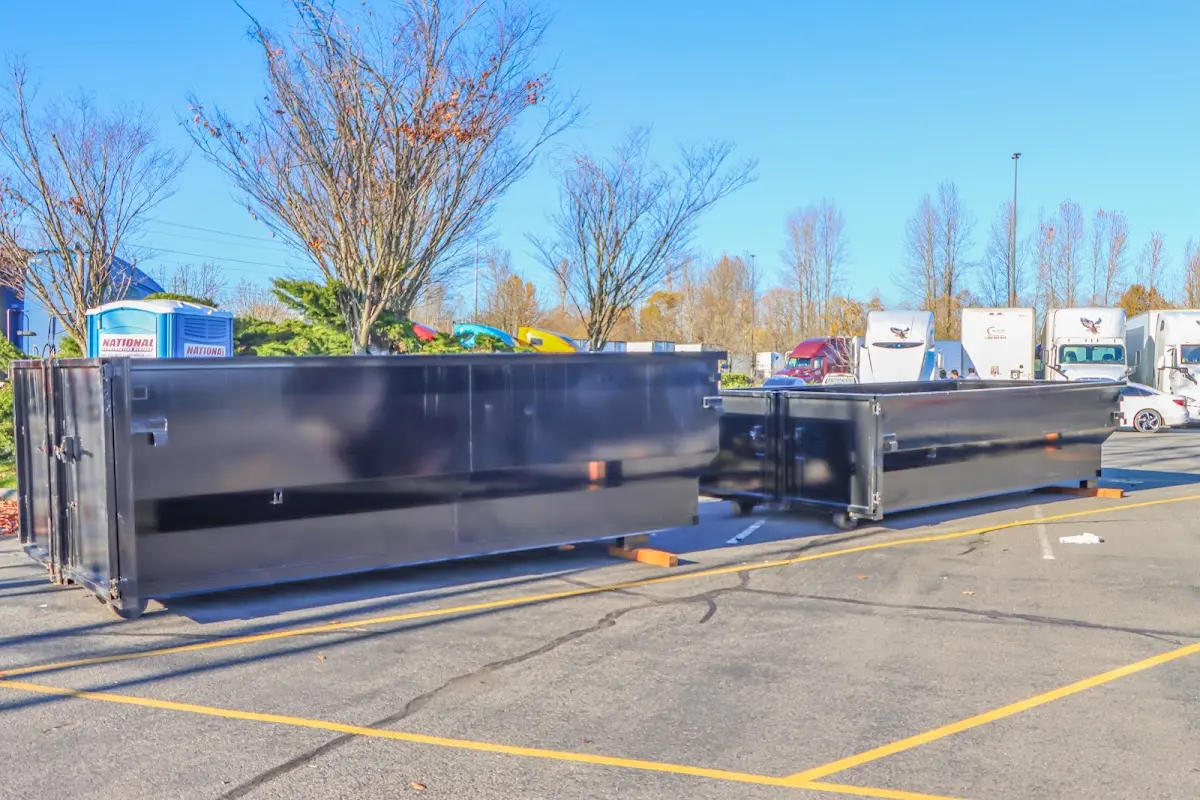 Professional dumpster rental service with roll-off container on residential driveway in Easton